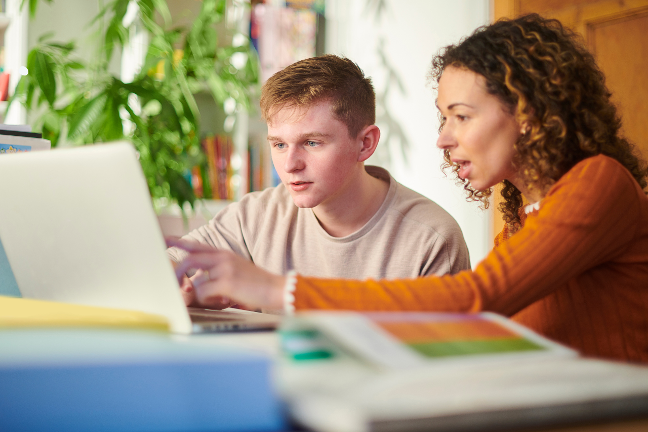 A tutor teaching her teenage student.